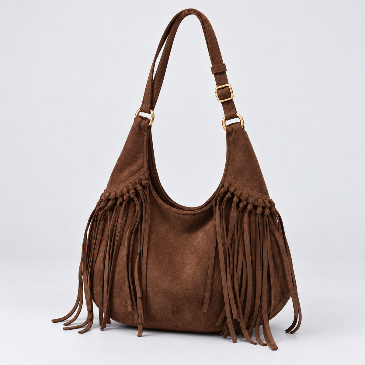 Odette dark brown fringe shoulder bag on a cool grey studio background